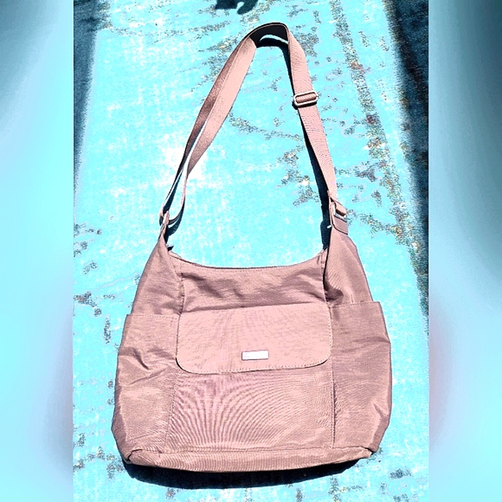 Grey Baggalini cross body hobo bag with bottle pockets on sides. 14" x 27"L